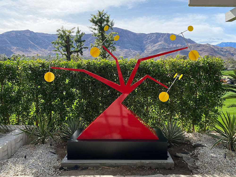 red mid century sculpture palm springs mountains