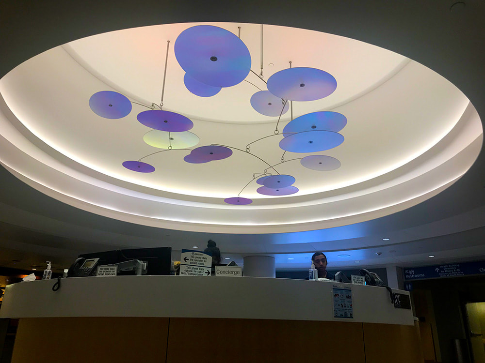 front desk of a hospital with hanging mobile above